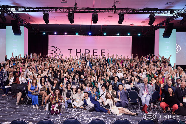 large group of brand ambassadors on stage at the THREE International convention in anaheim